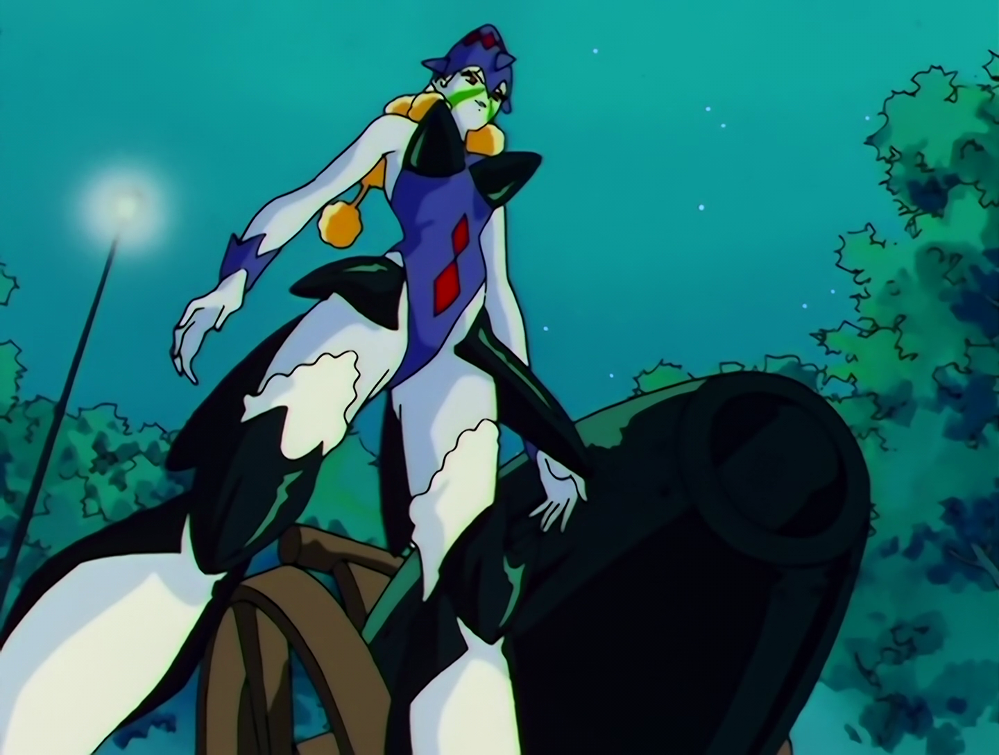 Do Kanko, a Lemures from Sailor Moon episode 130. She has pale white skin and is wearing a blue outfit with a bullet-shaped hat. Her outfit also contains multiple metal pieces, including a bullet-shaped bra. She’s standing next to a large cannon.